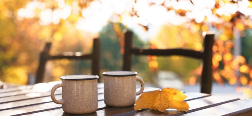 A mug on a wooden outdoor cafe table